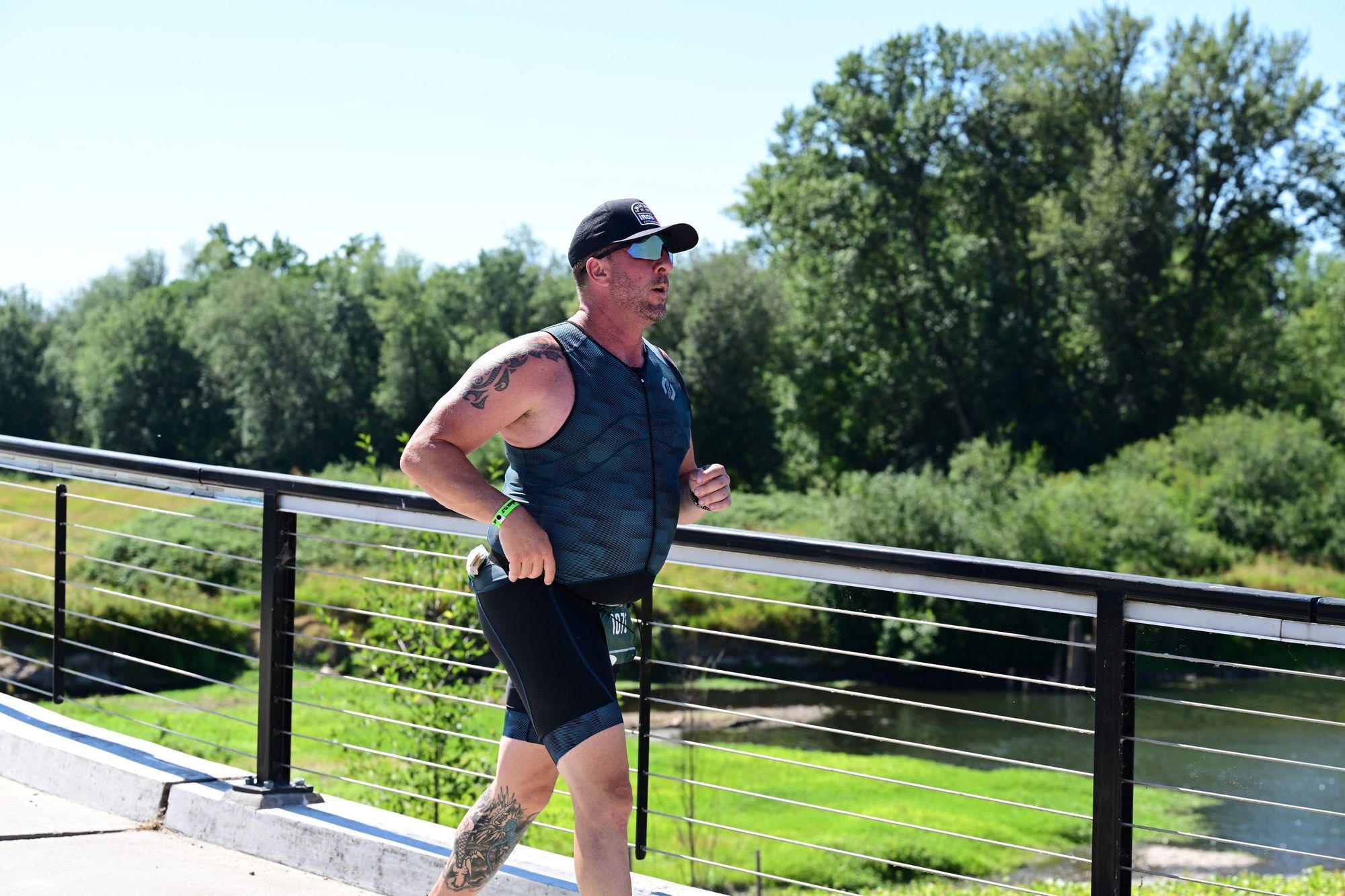 Ben Baxter running across a bridge on the run course at IRONMAN 70.3 Oregon