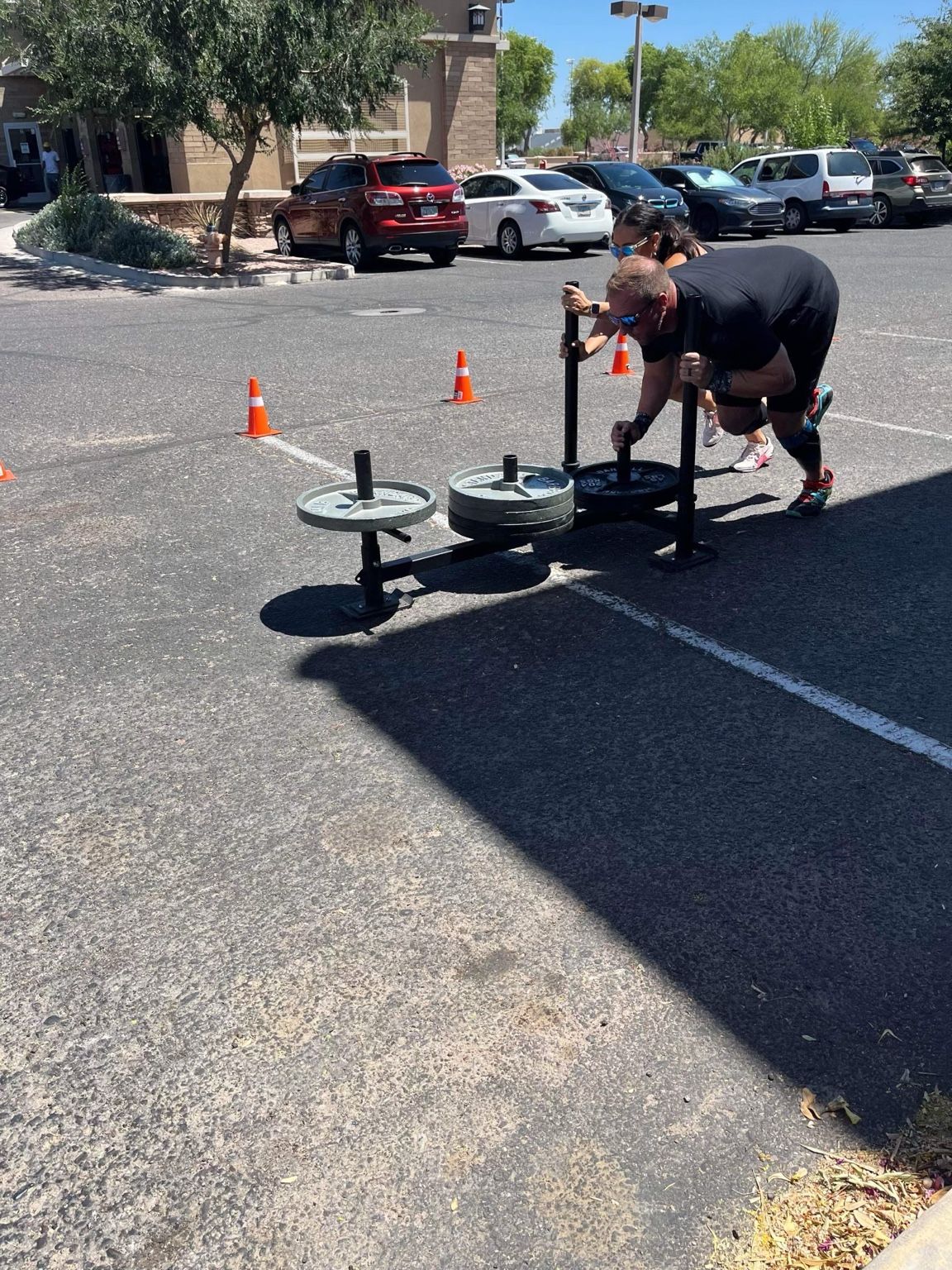 Athlete pushing a weighted sled outdoors